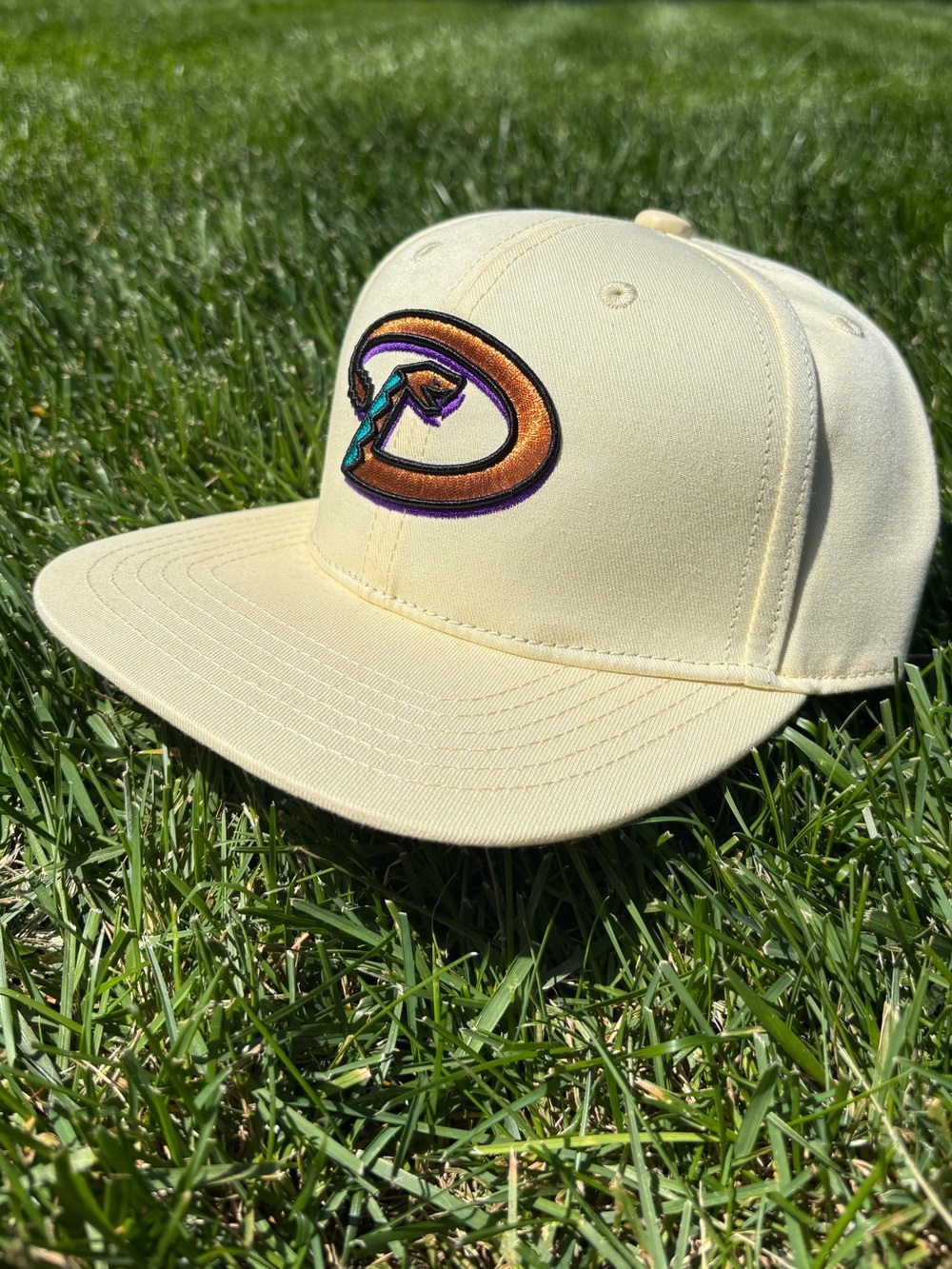 Cream Diamondbacks Snapback Hat with Orange & Teal Logo